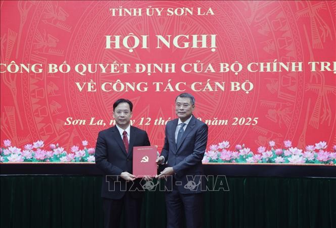Le Minh Hung (der.), miembro del Buró Político, secretario del Comité Central del Partido y jefe de su Comisión de Organización, presenta la decisión de nombramiento a Hoang Van Nghiem. (Foto: VNA)