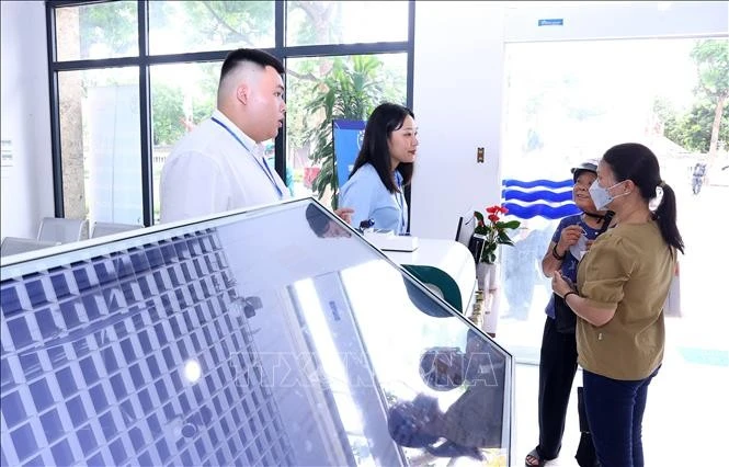 Funcionarios del barrio de Tay Ho, Hanoi, guían a las personas a realizar los trámites administrativos (Foto: VNA)